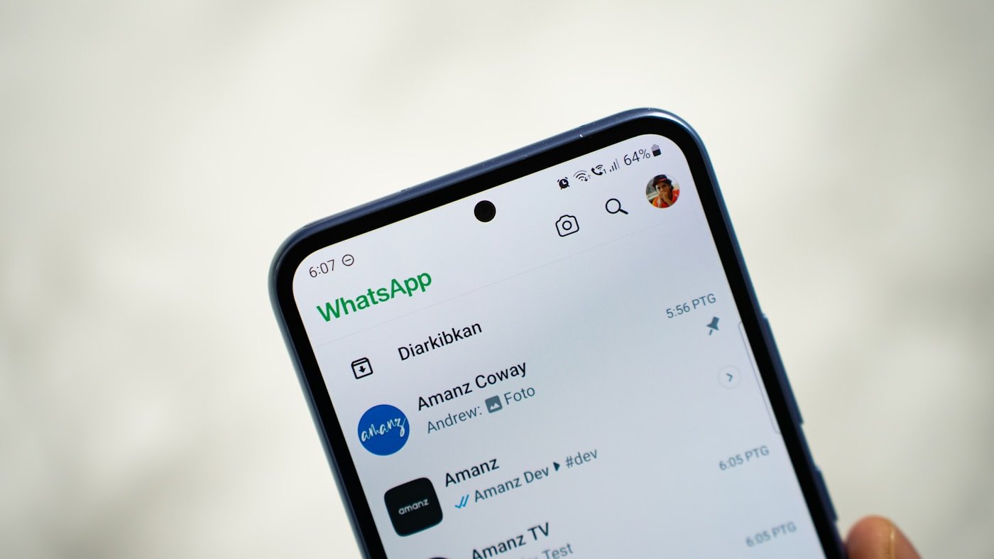 A photographed WhatsApp Android interface provides usage context.