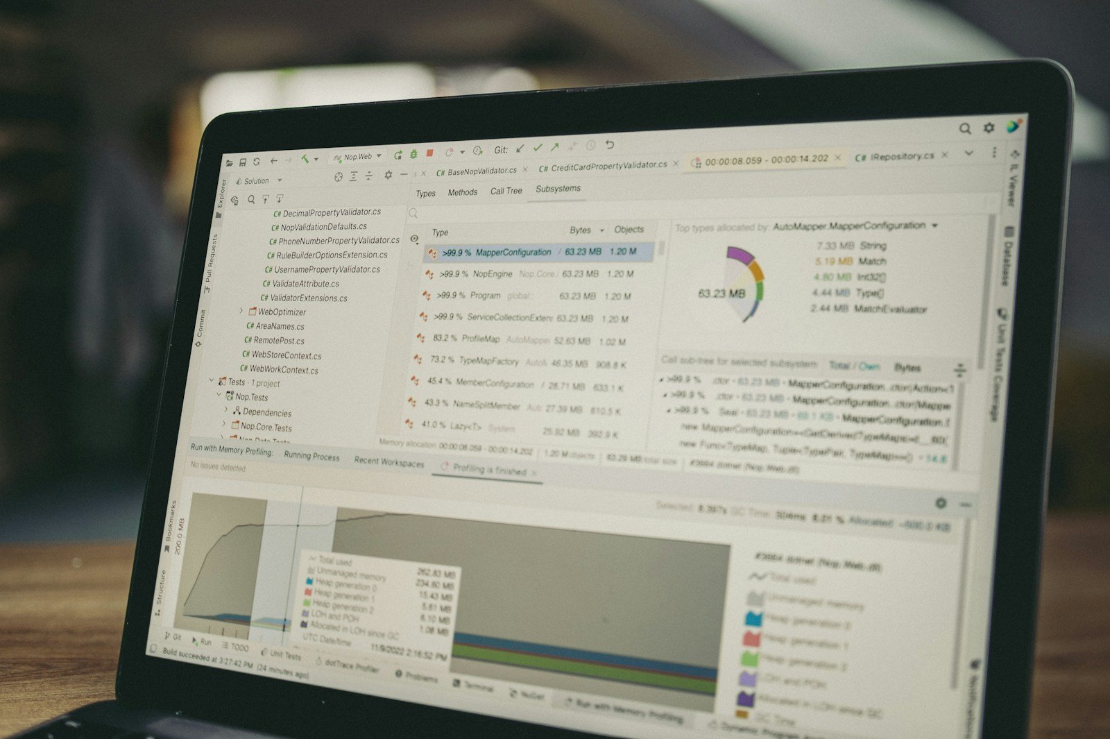 A laptop displaying code and data charts