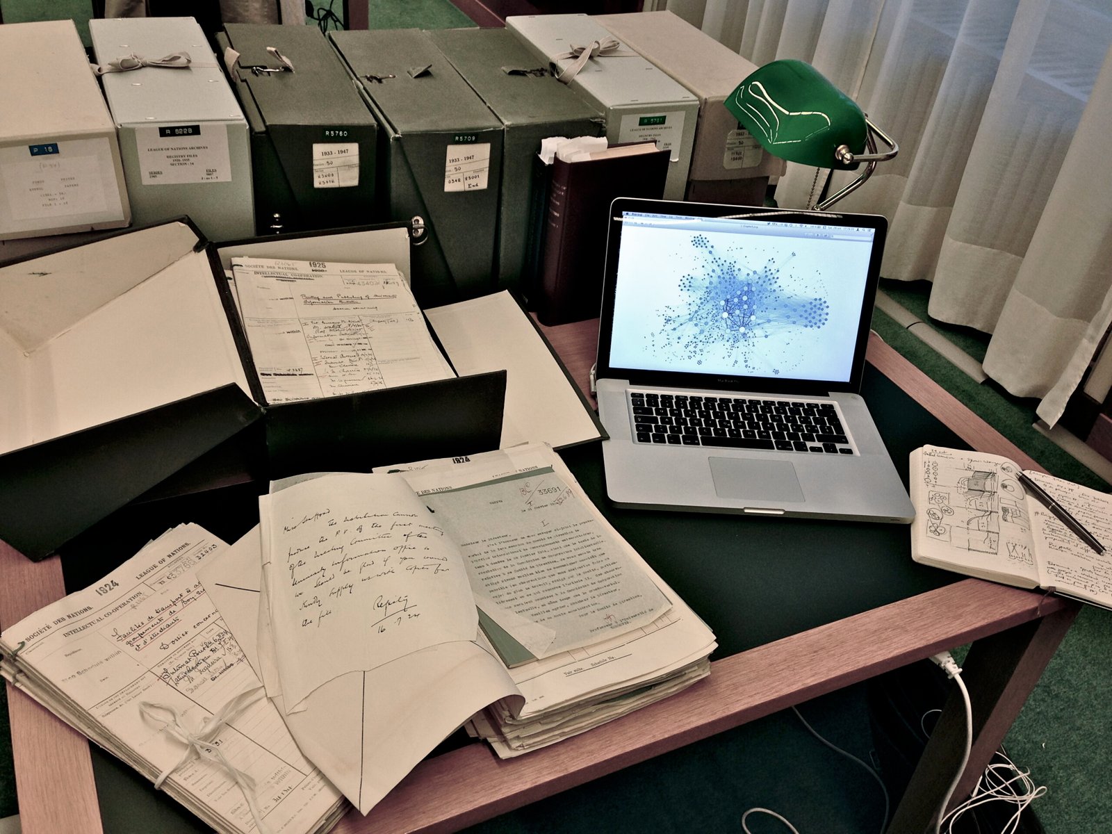 A laptop displaying a visual network of documents