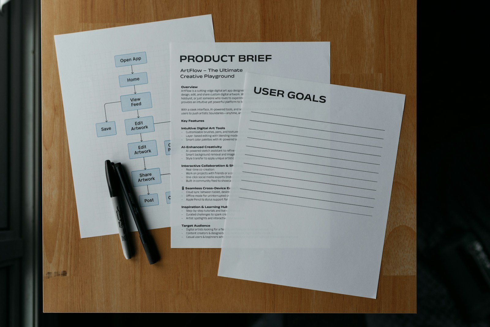Printed documents and a pen on a wooden desk