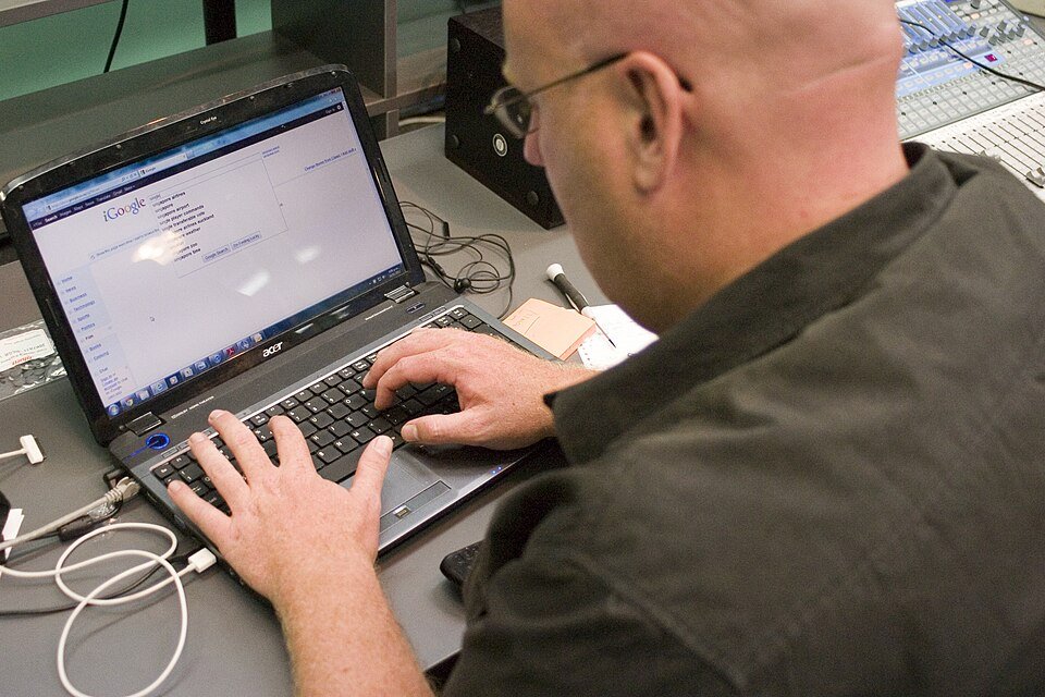 Person using a laptop to browse Google Search