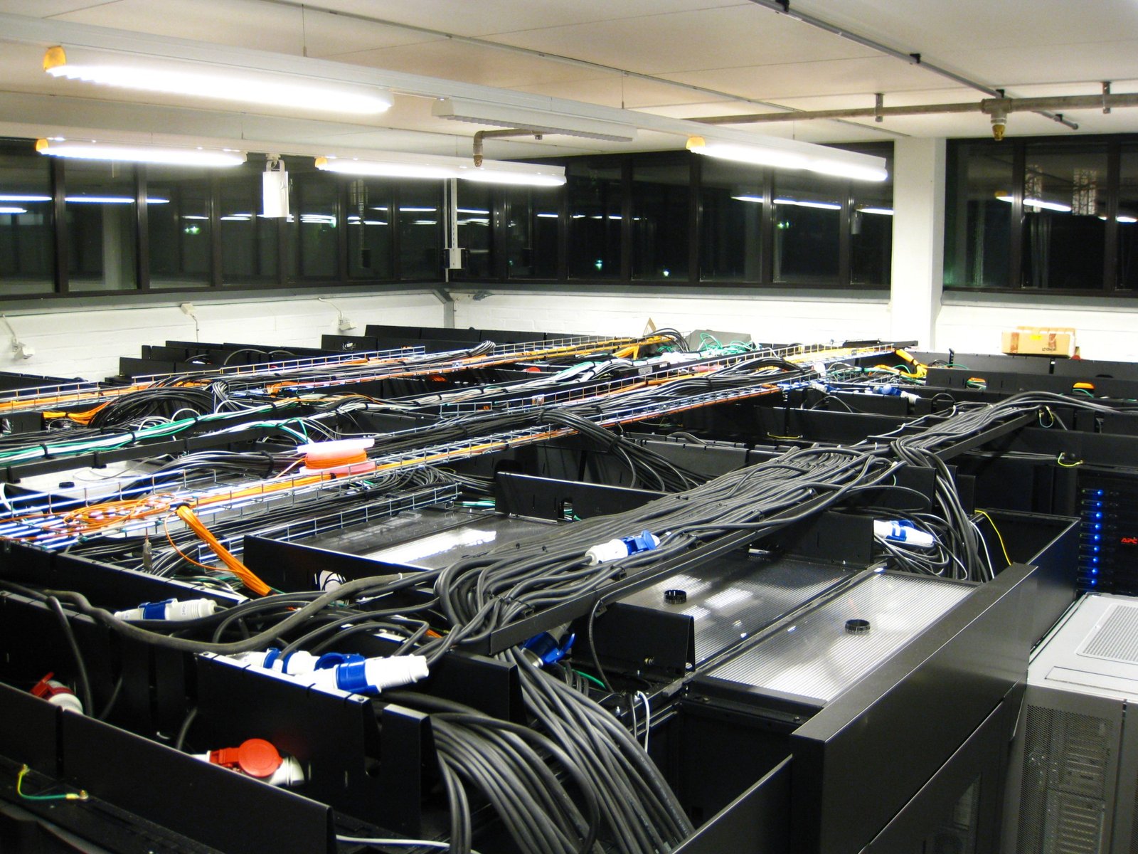 A real computer server room filled with cables and racks