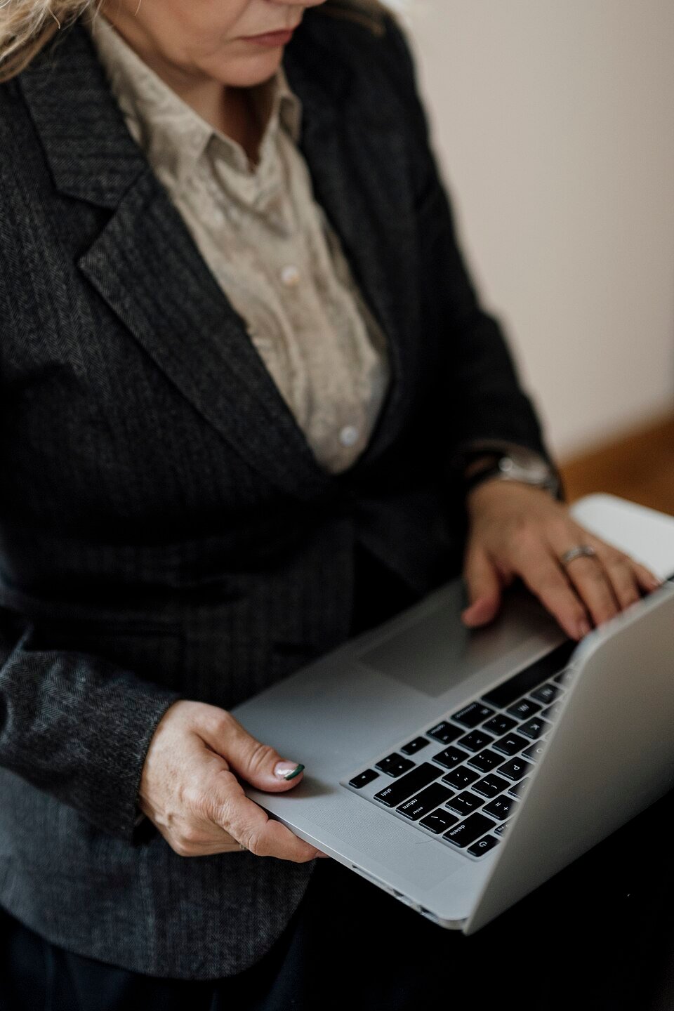 A woman working on a laptop in a bright office